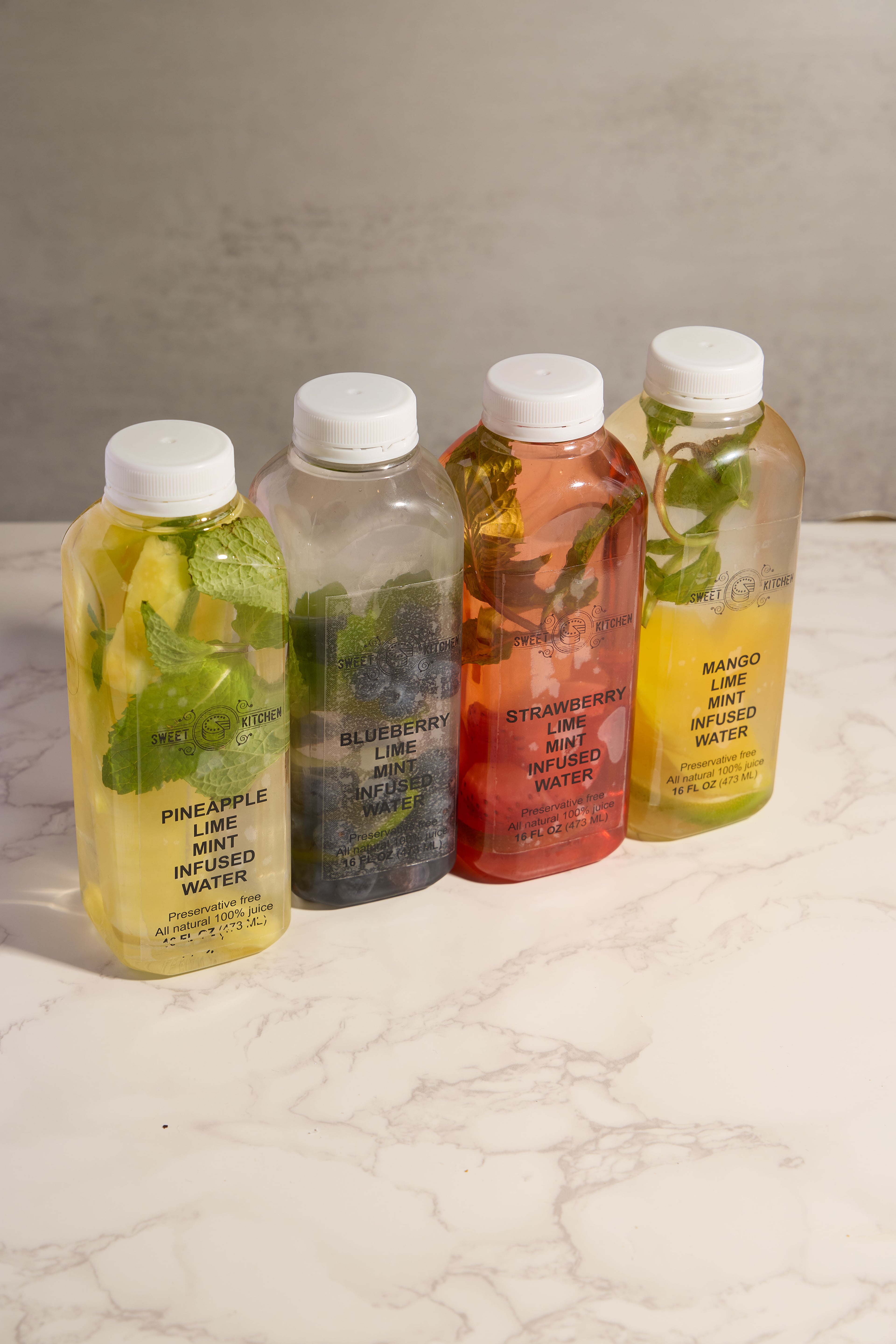 Sweet Kitchen NJ house-made infused waters — blueberry lime mint, pineapple, strawberry, and mango